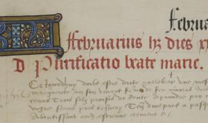 texte de manuscrits avec une lettrine, une première ligne écrite en couleur rouge et la suite de couleur marron