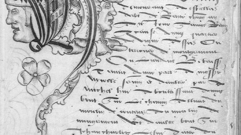 Lettre H illustrée de têtes et d’un dragon